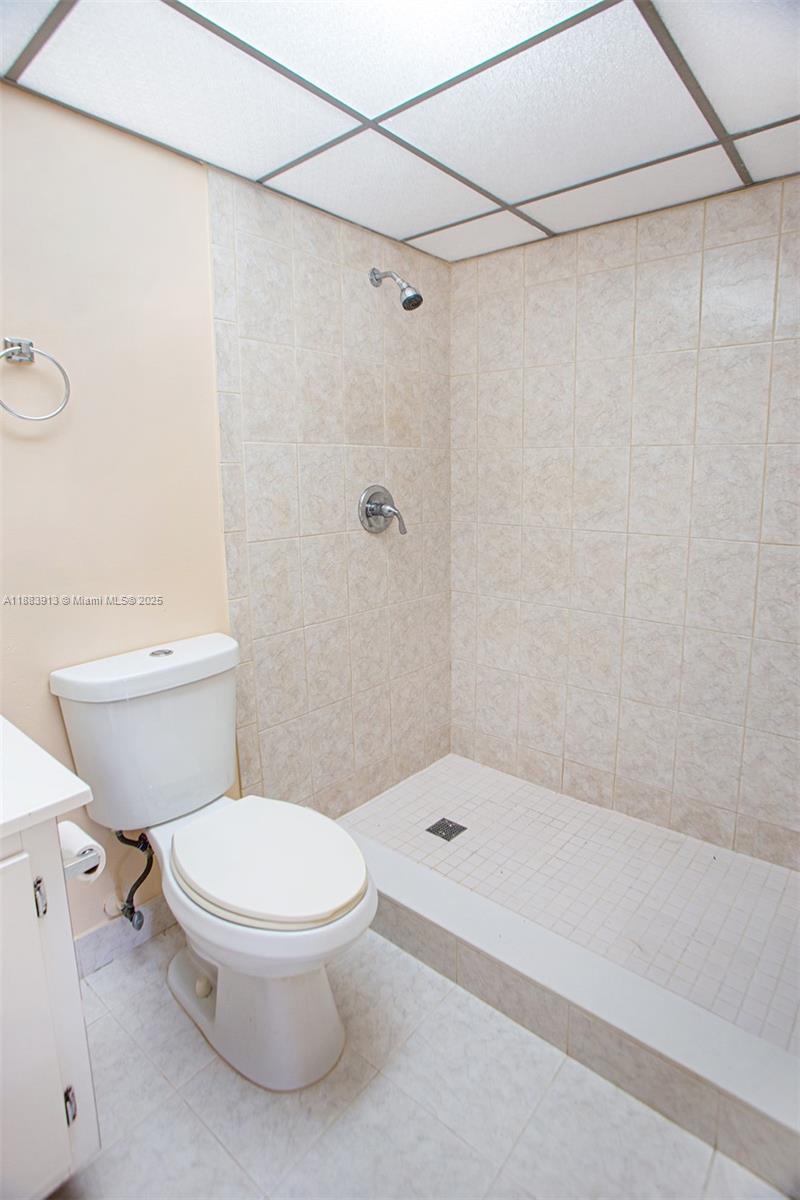 9711 West McNab Road, Unit 203 Tamarac, FL 33321 - Photo 21 of 37 a white toilet sitting next to a bath tub