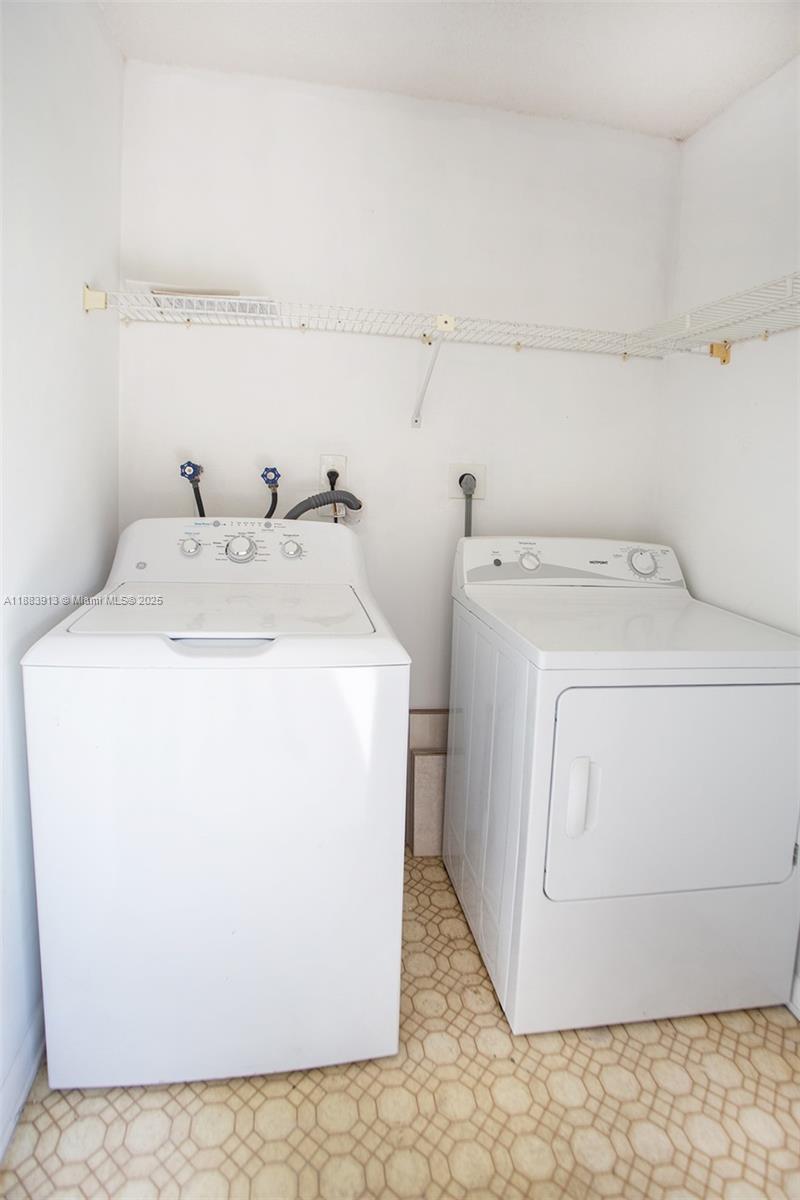 9711 West McNab Road, Unit 203 Tamarac, FL 33321 - Photo 23 of 37 a utility room with dryer and washer