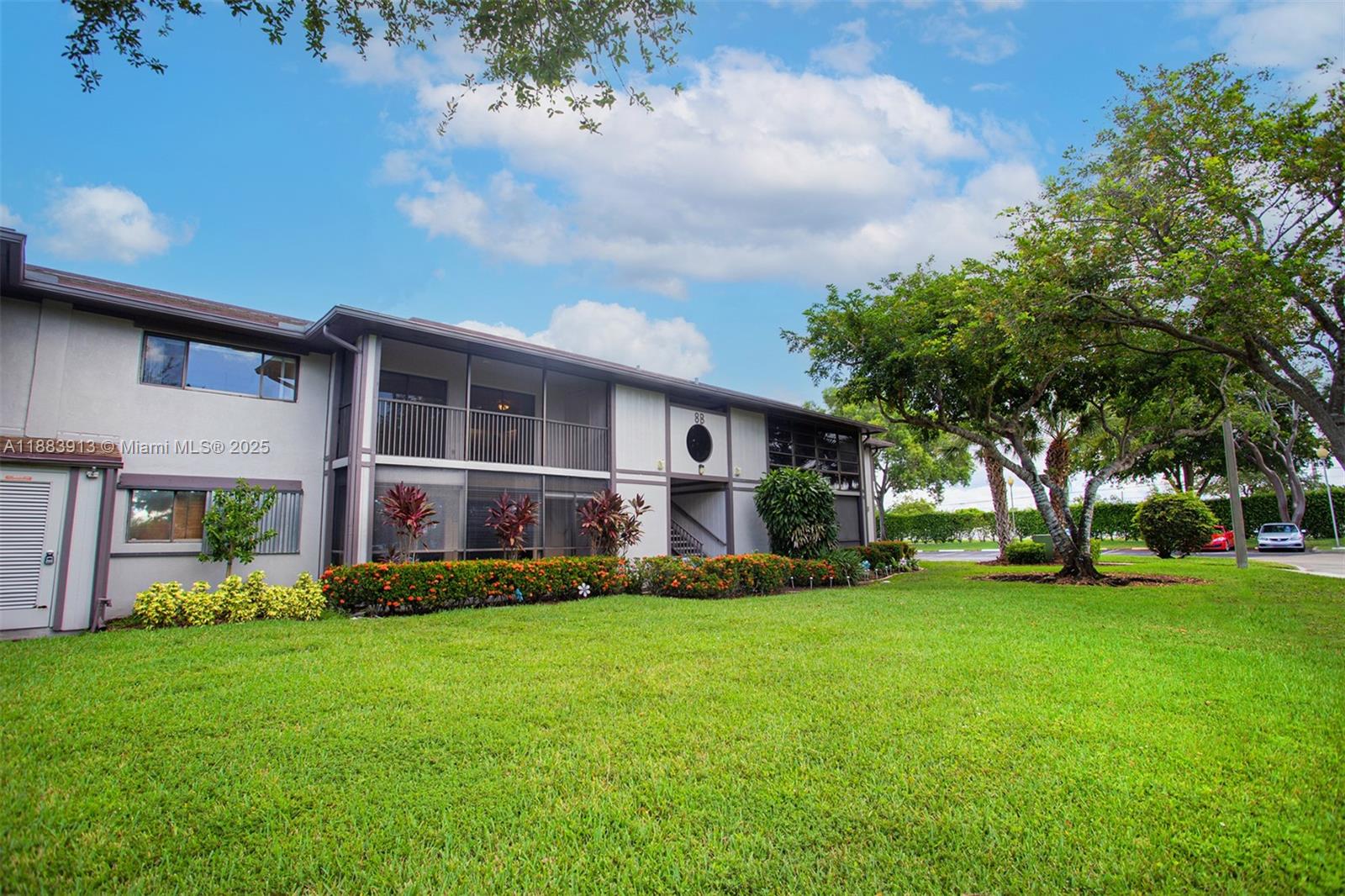 9711 West McNab Road, Unit 203 Tamarac, FL 33321 - Photo 27 of 37 a view of a house with a big yard and large trees