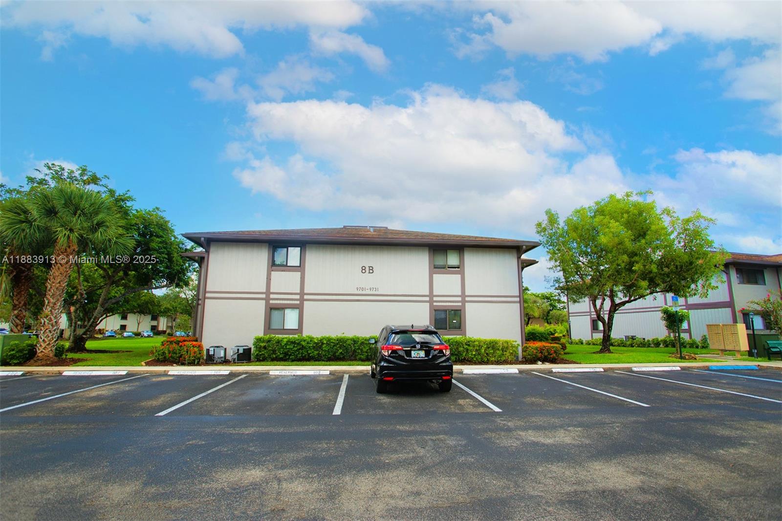 9711 West McNab Road, Unit 203 Tamarac, FL 33321 - Photo 28 of 37 a view of a car parked in front of a house