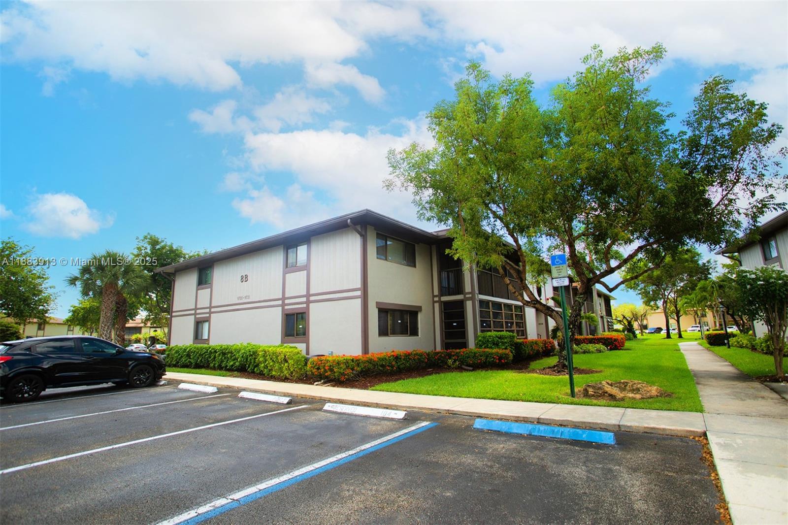 9711 West McNab Road, Unit 203 Tamarac, FL 33321 - Photo 29 of 37 a view of a parked cars in front of a building