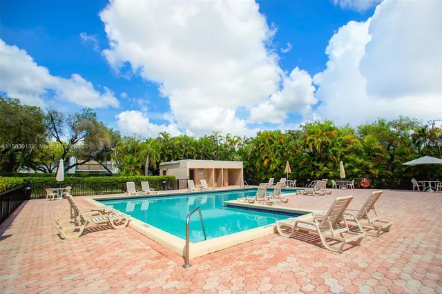 swimming pool view with a seating space