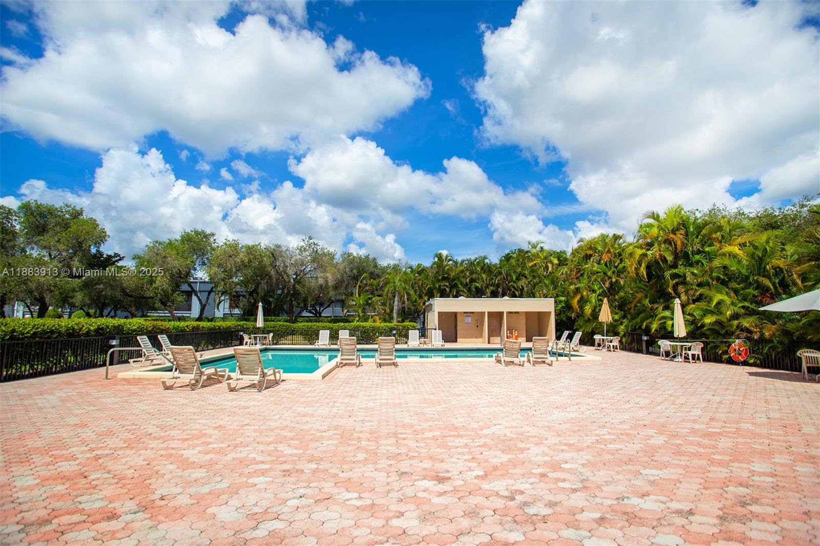 9711 West McNab Road, Unit 203 Tamarac, FL 33321 - Photo 34 of 37 a view of a lake with a house in the background