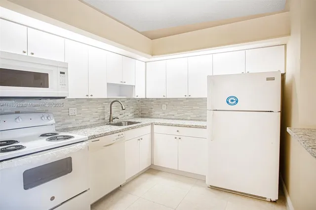 a kitchen with a stove a sink and a refrigerator