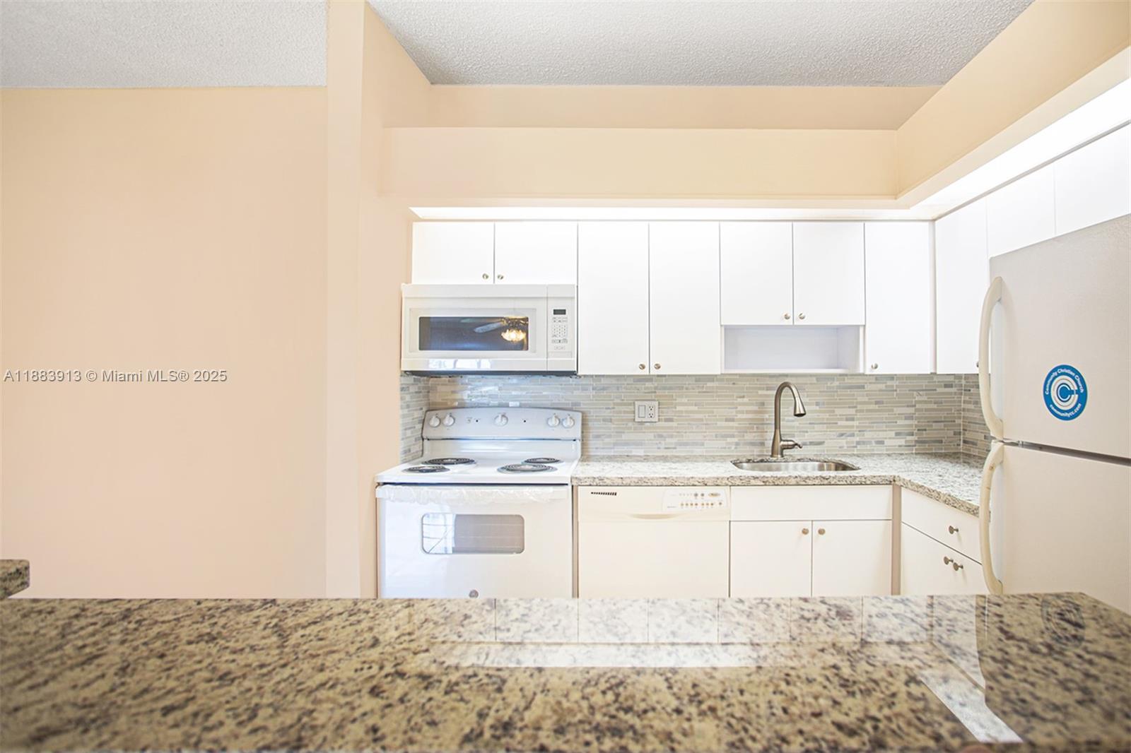 9711 West McNab Road, Unit 203 Tamarac, FL 33321 - Photo 10 of 37 a kitchen with a sink cabinets and window