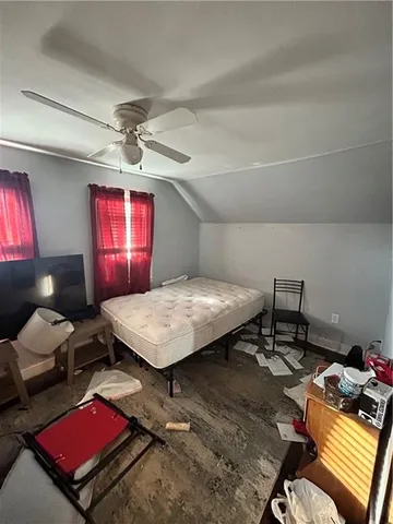 a bed room with a bed mirror and a window