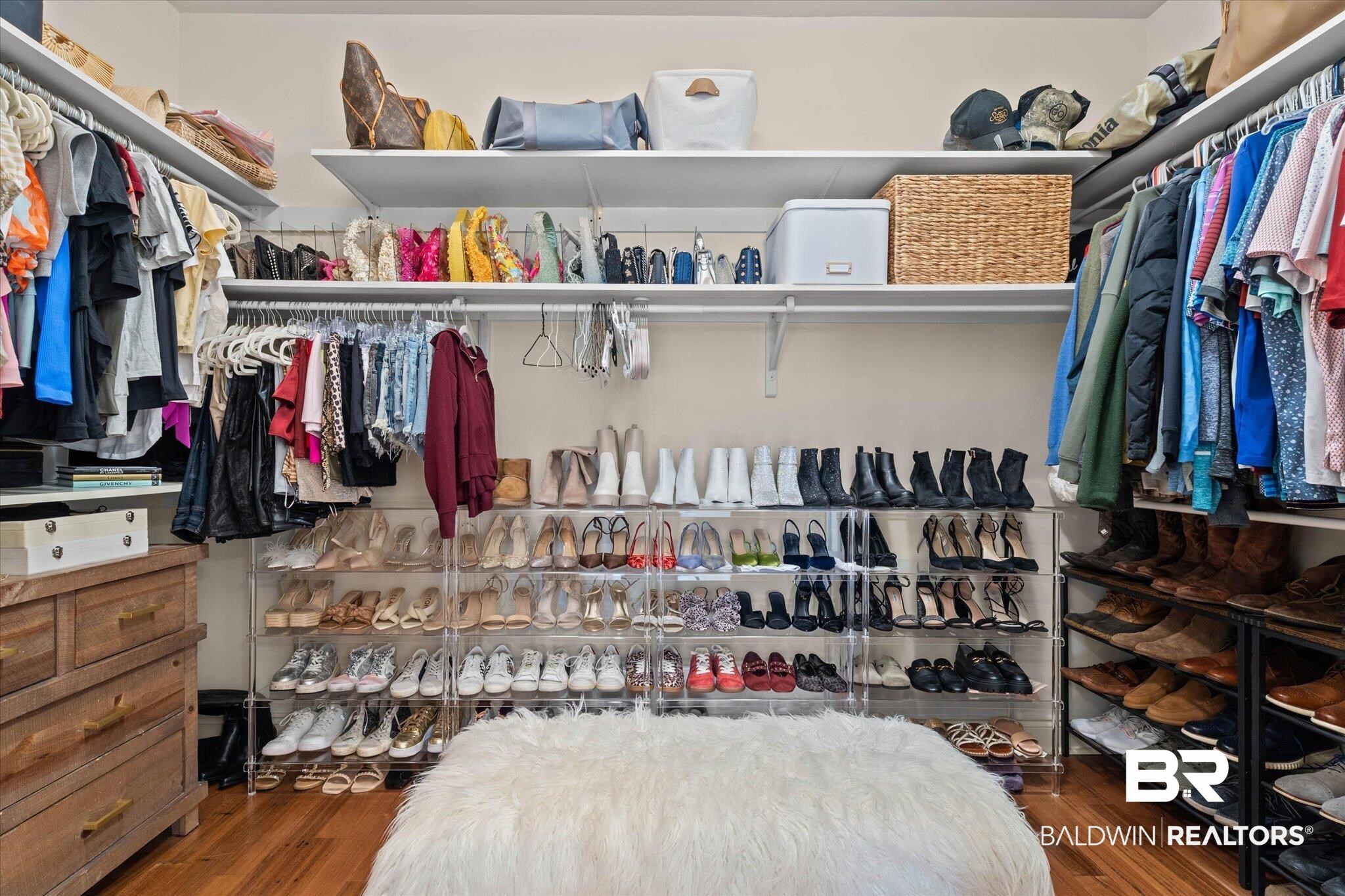 3459 Rue Royal Mobile, AL 36693 - Photo 17 of 31 Custom-designed walk-in closet featuring extensive built-in shelving, multiple hanging rods, durable wood-finish flooring, and a dedicated shoe storage system