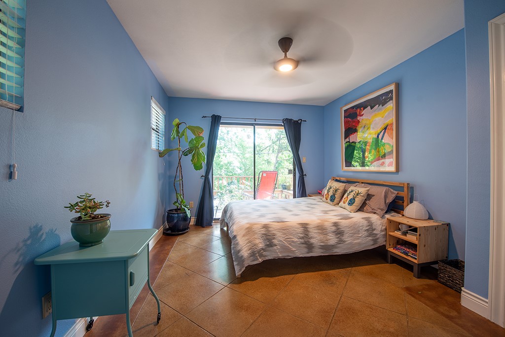 3609 Clawson Road, Unit A Austin, TX 78704 - Photo 10 of 17 Naturally illuminated bedroom features durable tile flooring and convenient exterior access to a private balcony.