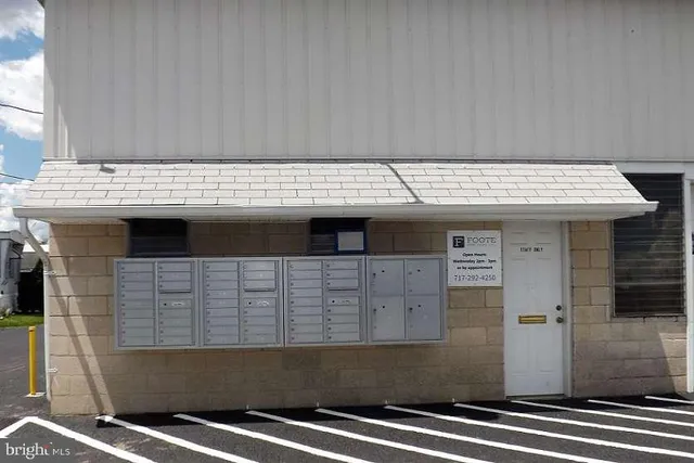 a view of kitchen with granite countertop sink and cabinets