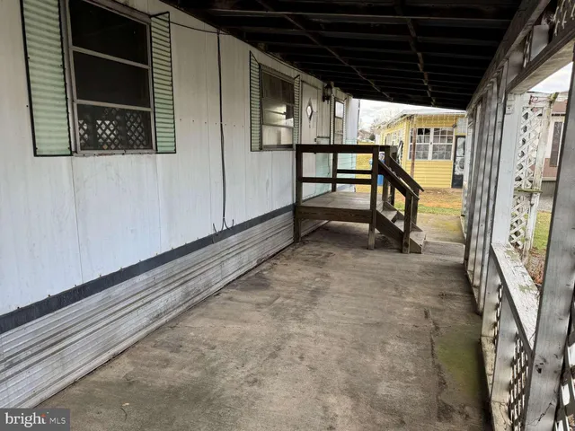 a view of a porch with a table and chairs
