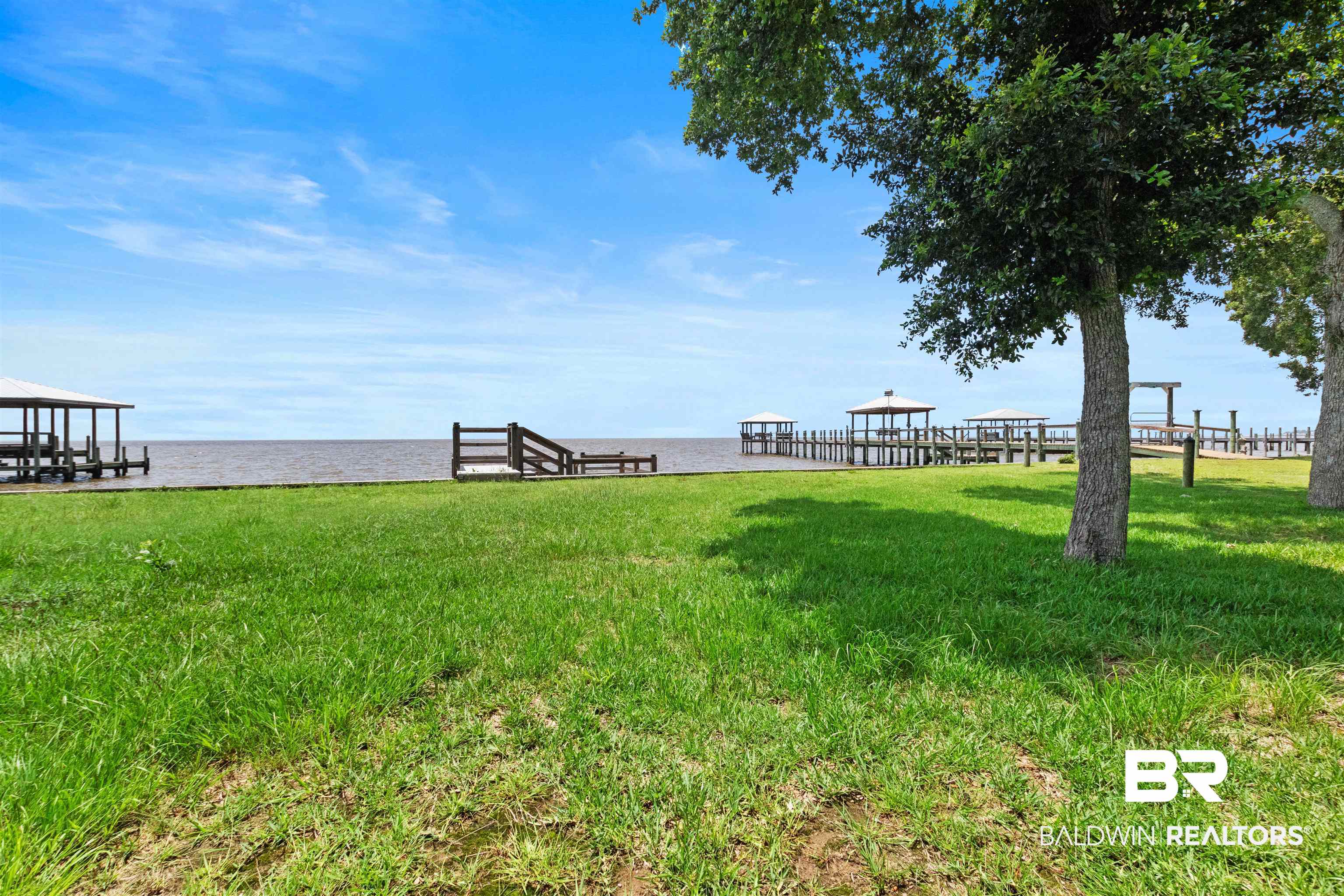 9581 South Bay Street Foley, AL 36535 - Photo 34 of 44 Expansive waterfront property featuring a lush green lawn and mature trees