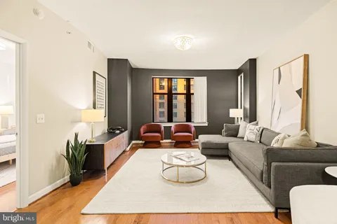 a living room with furniture rug and window
