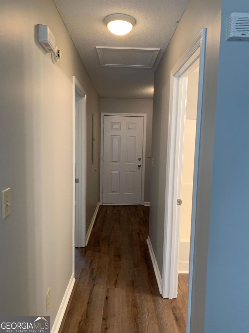 704 Green Street, Unit B Fort Valley, GA 31030 - Photo 9 of 11 a view of a hallway with wooden floor