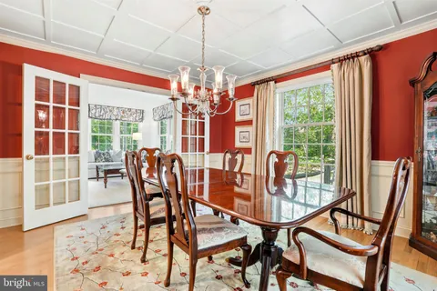 a view of a dining room with furniture wooden floor and chandelier