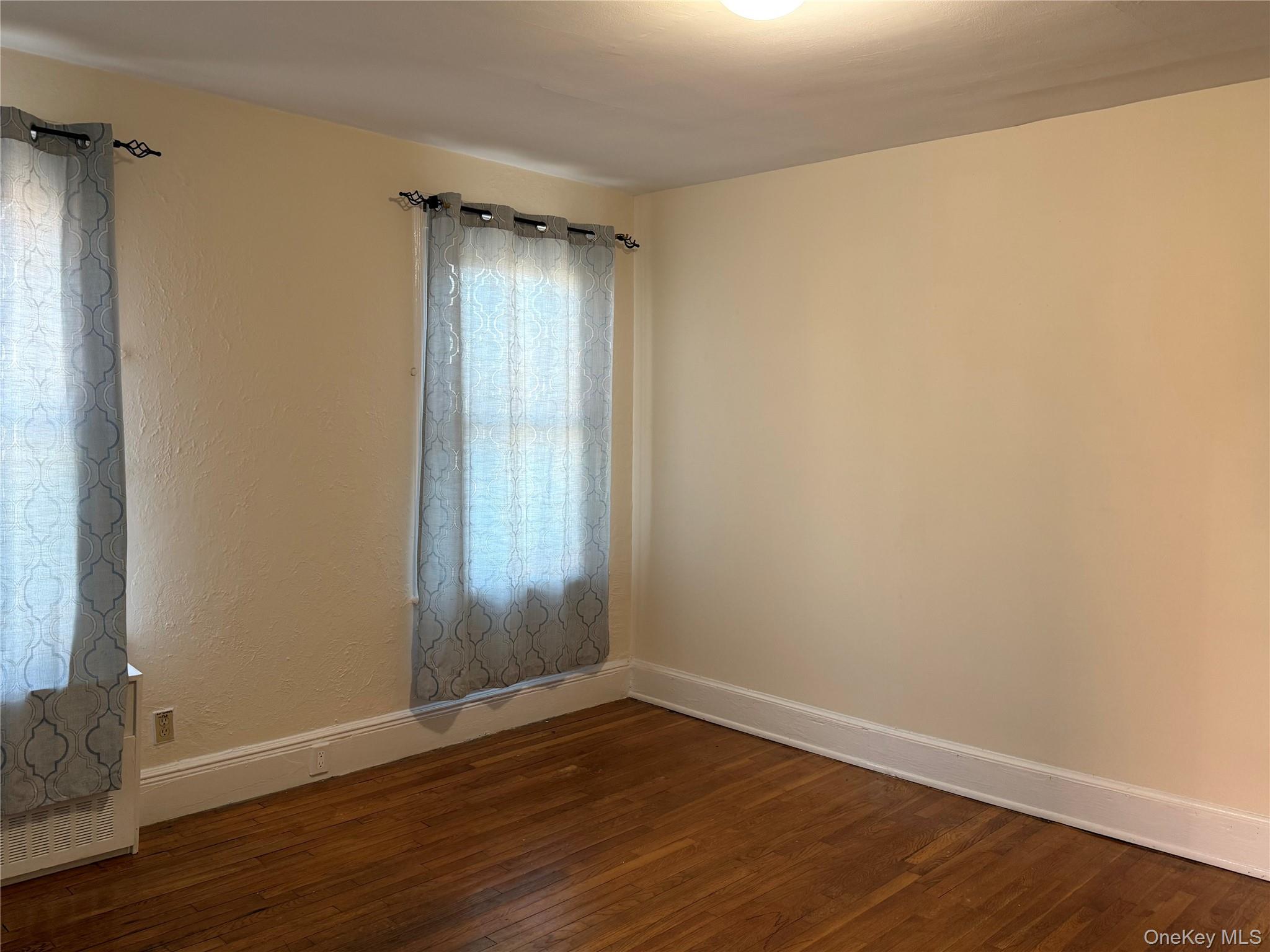 4759 Matilda Avenue, Unit 2 Bronx, NY 10470 - Photo 5 of 10 a view of an empty room with wooden floor and a window
