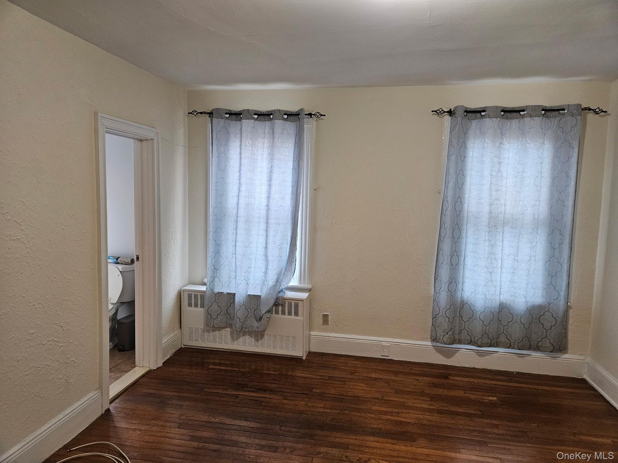 4759 Matilda Avenue, Unit 2 Bronx, NY 10470 - Photo 6 of 10 a view of an empty room with wooden floor and a window