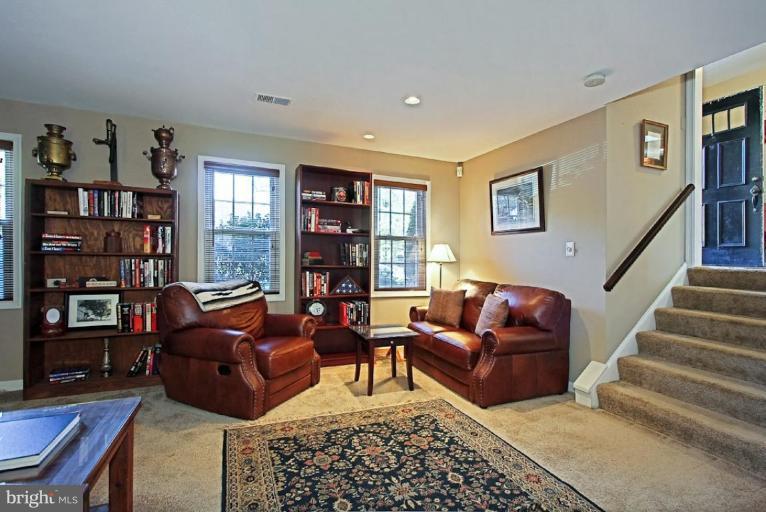 11911 Riders Lane Reston, VA 20191 - Photo 14 of 30 a living room with furniture and a book shelf