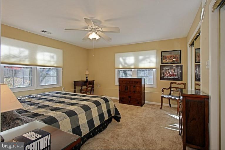 11911 Riders Lane Reston, VA 20191 - Photo 22 of 30 a bedroom with a bed and dresser
