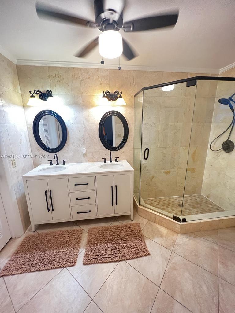 3324 Lakeview Boulevard Delray Beach, FL 33445 - Photo 22 of 36 a bathroom with a sink and a mirror