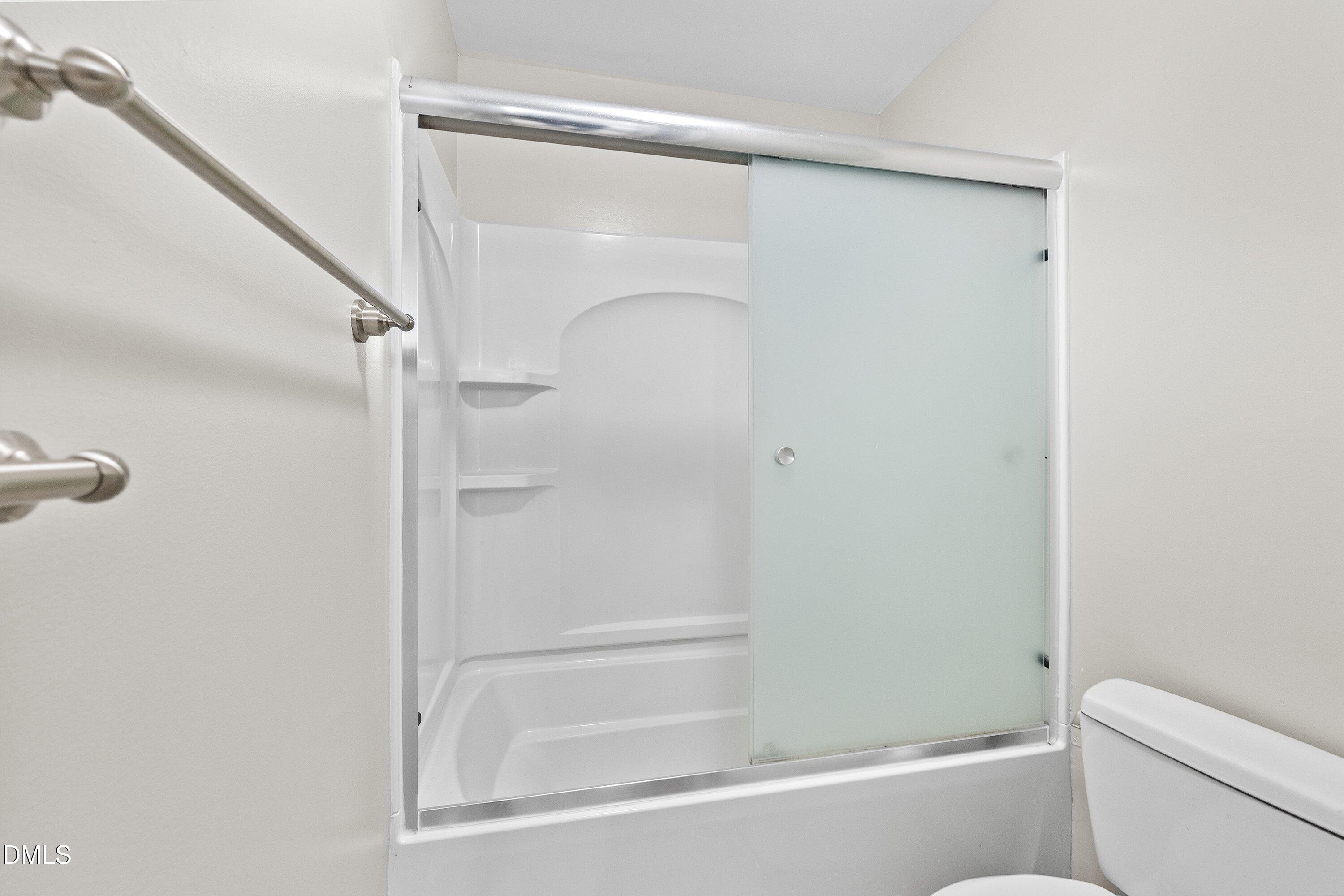 5917 Scalybark Road Durham, NC 27712 - Photo 26 of 47 a bathroom with a glass shower door