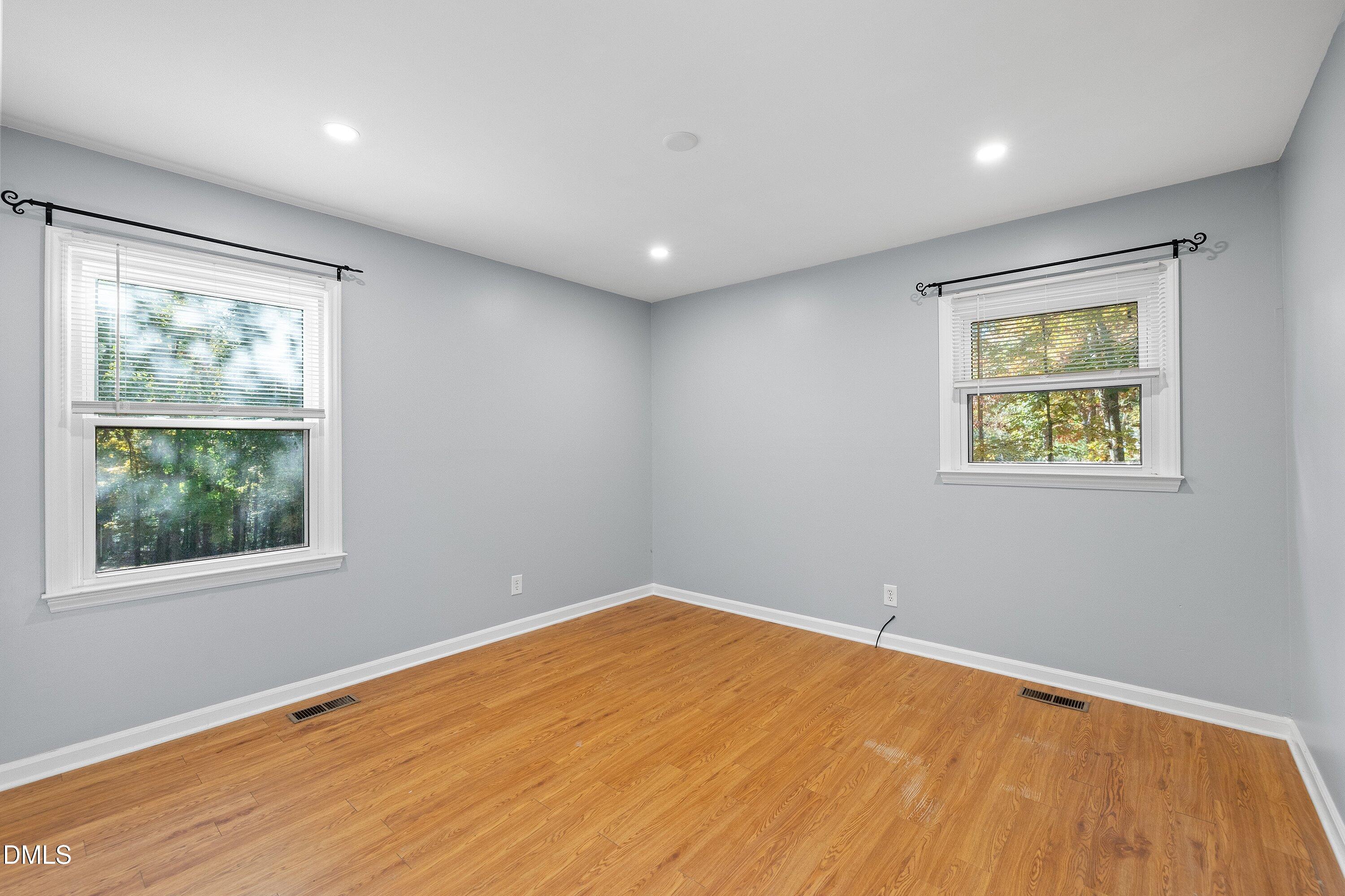 5917 Scalybark Road Durham, NC 27712 - Photo 27 of 47 a view of empty room with wooden floor and fan
