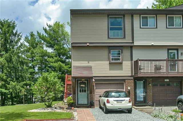 a view of a car parked in front of a house