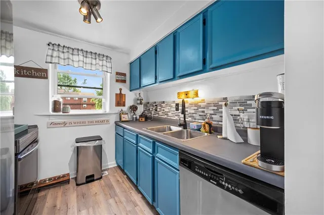 a kitchen with stainless steel appliances a sink stove and cabinets