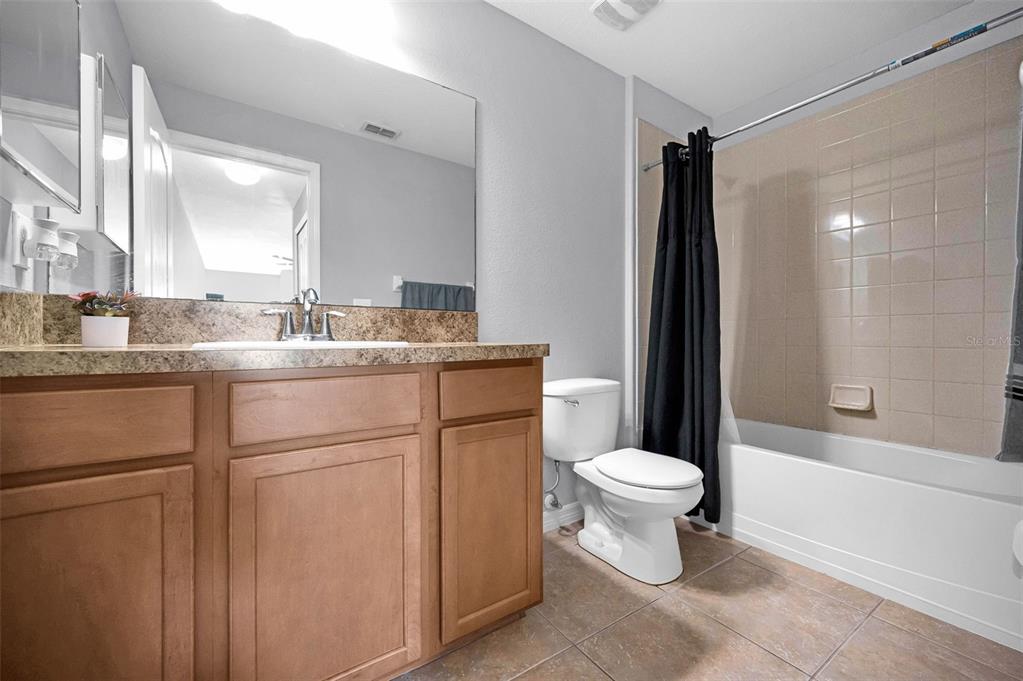 9736 Trumpet Vine Loop Trinity, FL 34655 - Photo 24 of 35 a bathroom with a sink toilet and shower