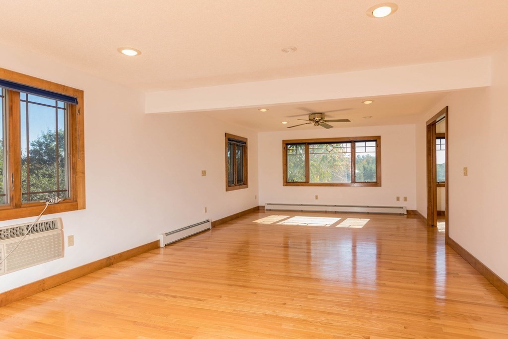 312 East Rindge Road Ashburnham, MA 01430 - Photo 9 of 23 a view of an empty room with wooden floor and a window