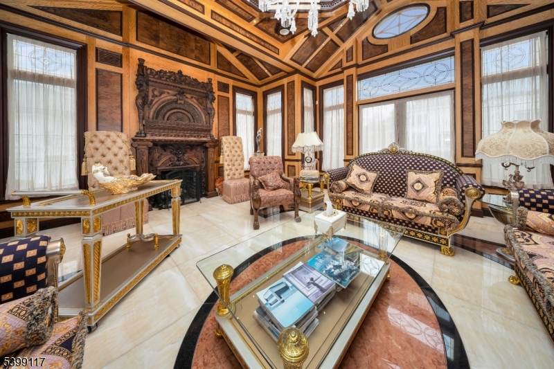 1 Hamilton Avenue Weehawken, NJ 07086 - Photo 12 of 40 a living room with furniture a fireplace and a large window