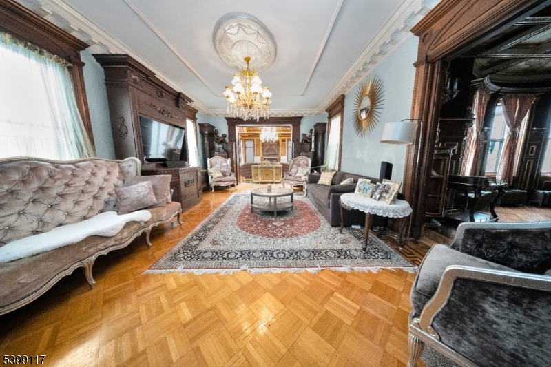 1 Hamilton Avenue Weehawken, NJ 07086 - Photo 14 of 40 a living room with furniture and a chandelier