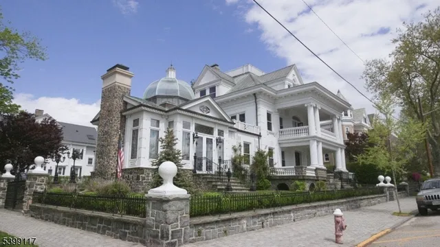 a front view of a house with a garden and plants