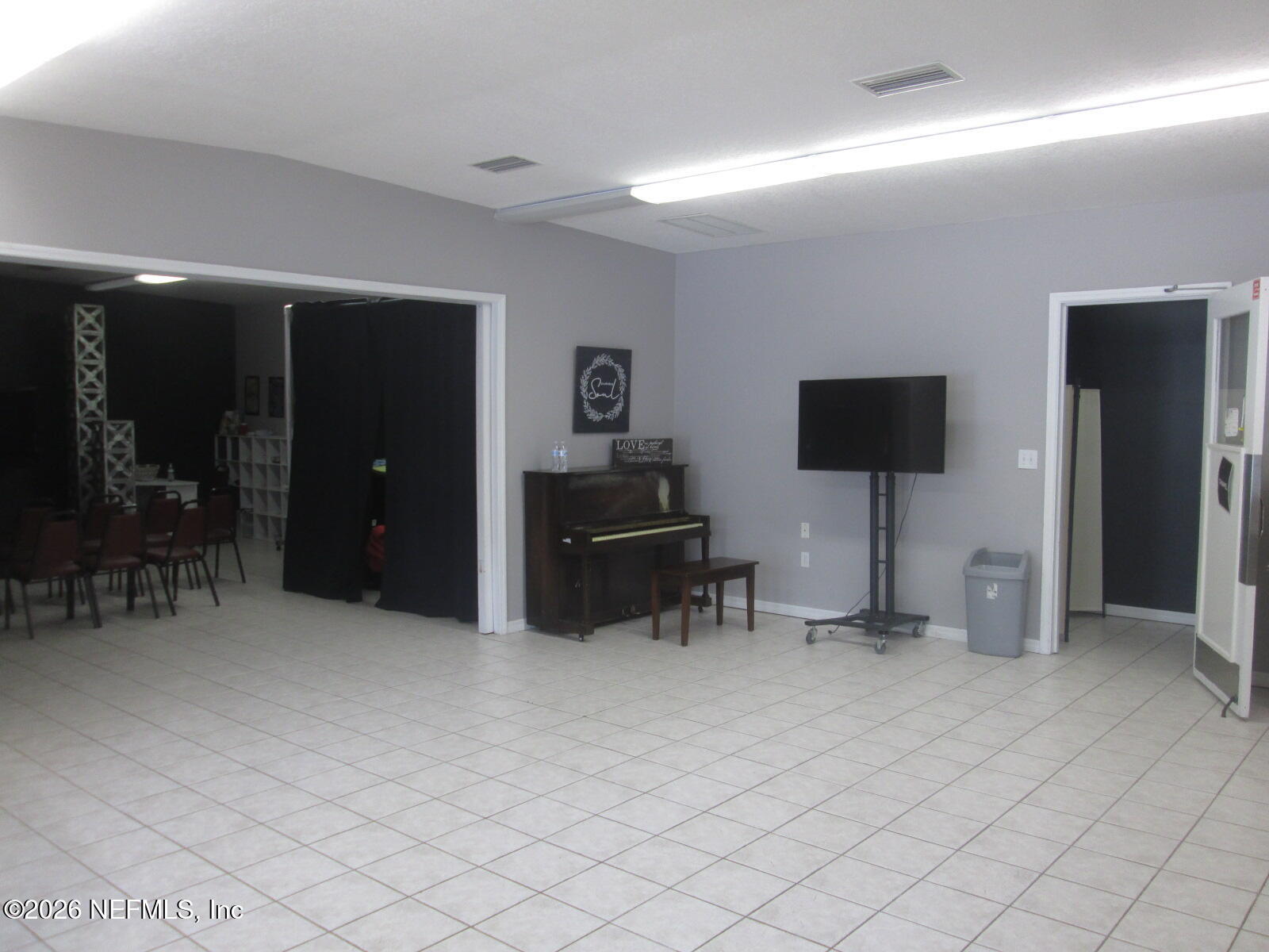 555 Highway 16 St. Augustine, FL 32084 - Photo 22 of 60 a living room with furniture and a flat screen tv