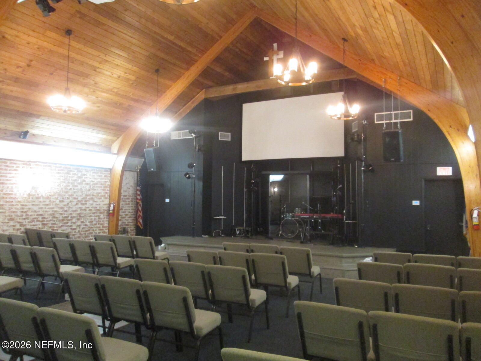 555 Highway 16 St. Augustine, FL 32084 - Photo 27 of 60 a media room with lots of chairs and a projector screen