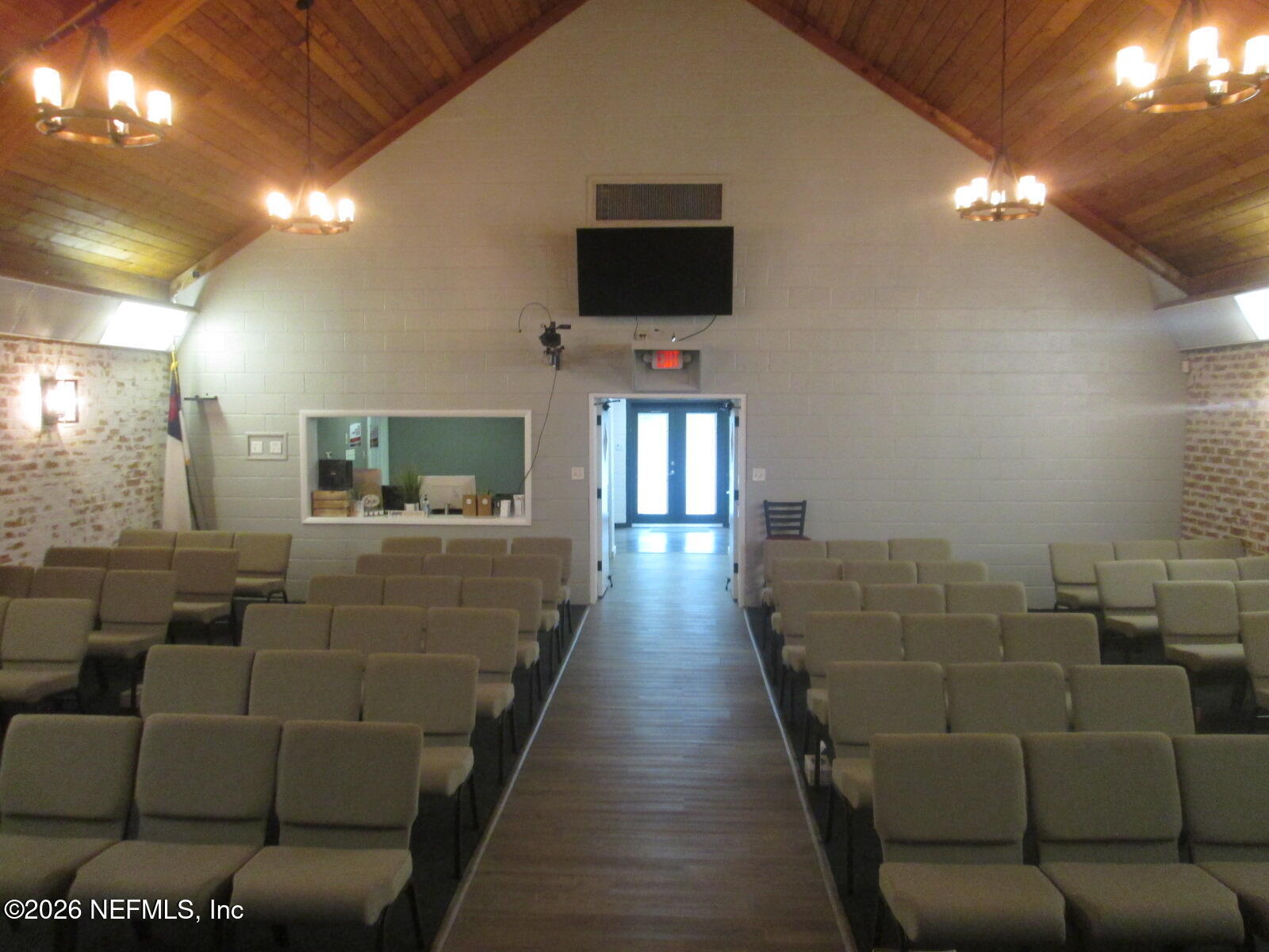 555 Highway 16 St. Augustine, FL 32084 - Photo 29 of 60 a living room with furniture and a flat screen tv