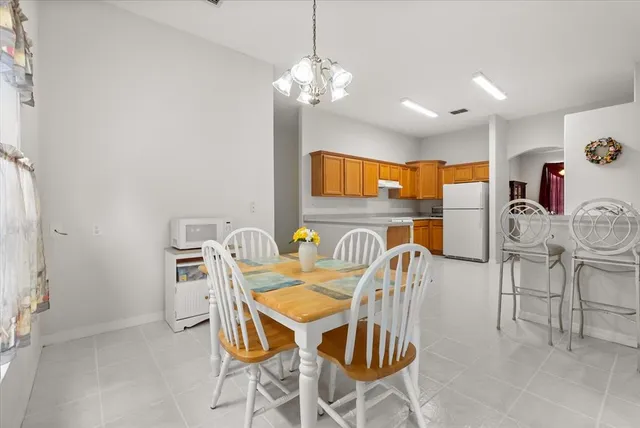 a dining room with furniture and chandelier