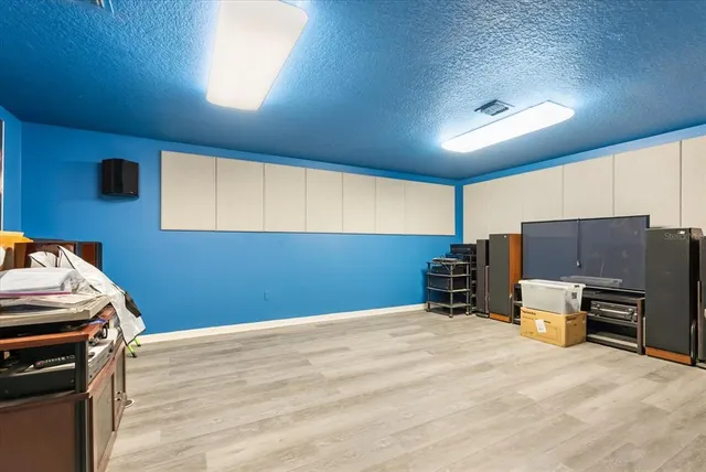 a bedroom with a bed a ceiling fan and a chandelier