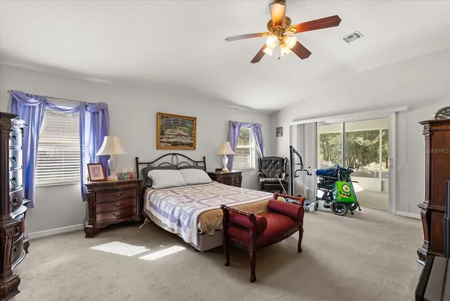 a bedroom with a bed dresser and a chandelier