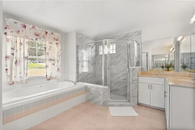 a spacious bathroom with a tub shower and sink