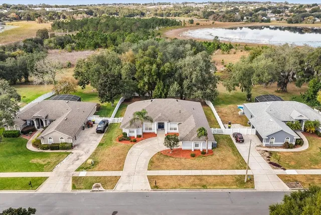 an aerial view of a house with garden space and lake view