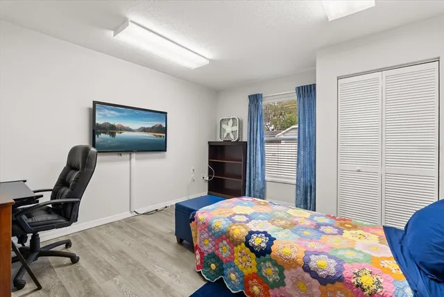 a bedroom with a bed and a chair