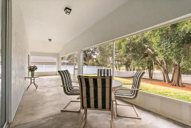 a view of a house with swimming pool and sitting area