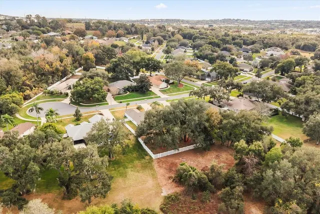 a aerial view of a residential apartment building with a yard