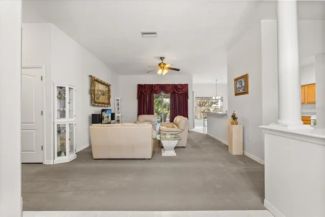 a living room with furniture and a chandelier