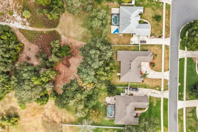 an aerial view of a house with garden space and ocean view