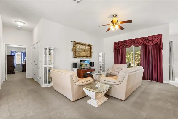 a living room with fireplace furniture and a large window