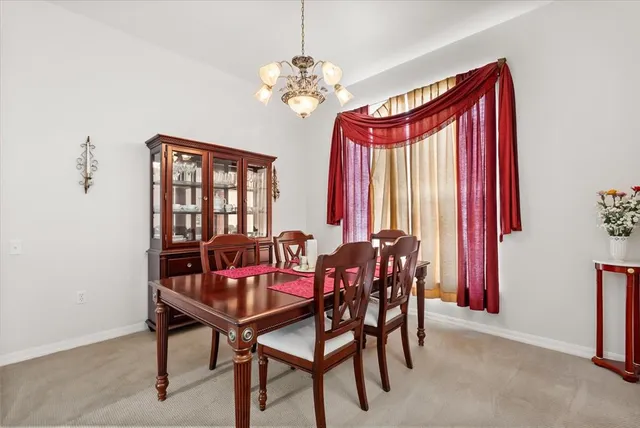 a view of a dining room with furniture and window