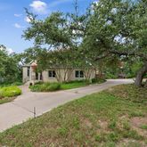 a front view of a house with yard and green space