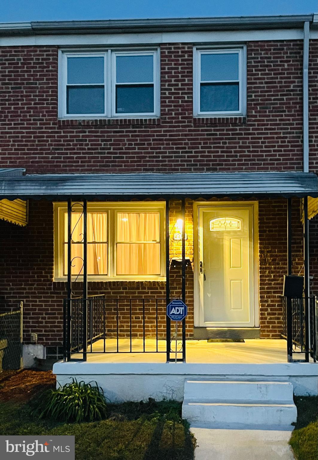 a view of a brick house with a large window