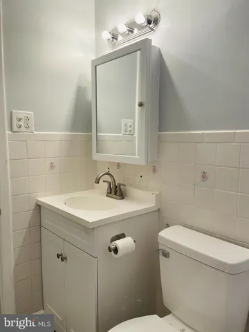 a bathroom with a sink a toilet and mirror